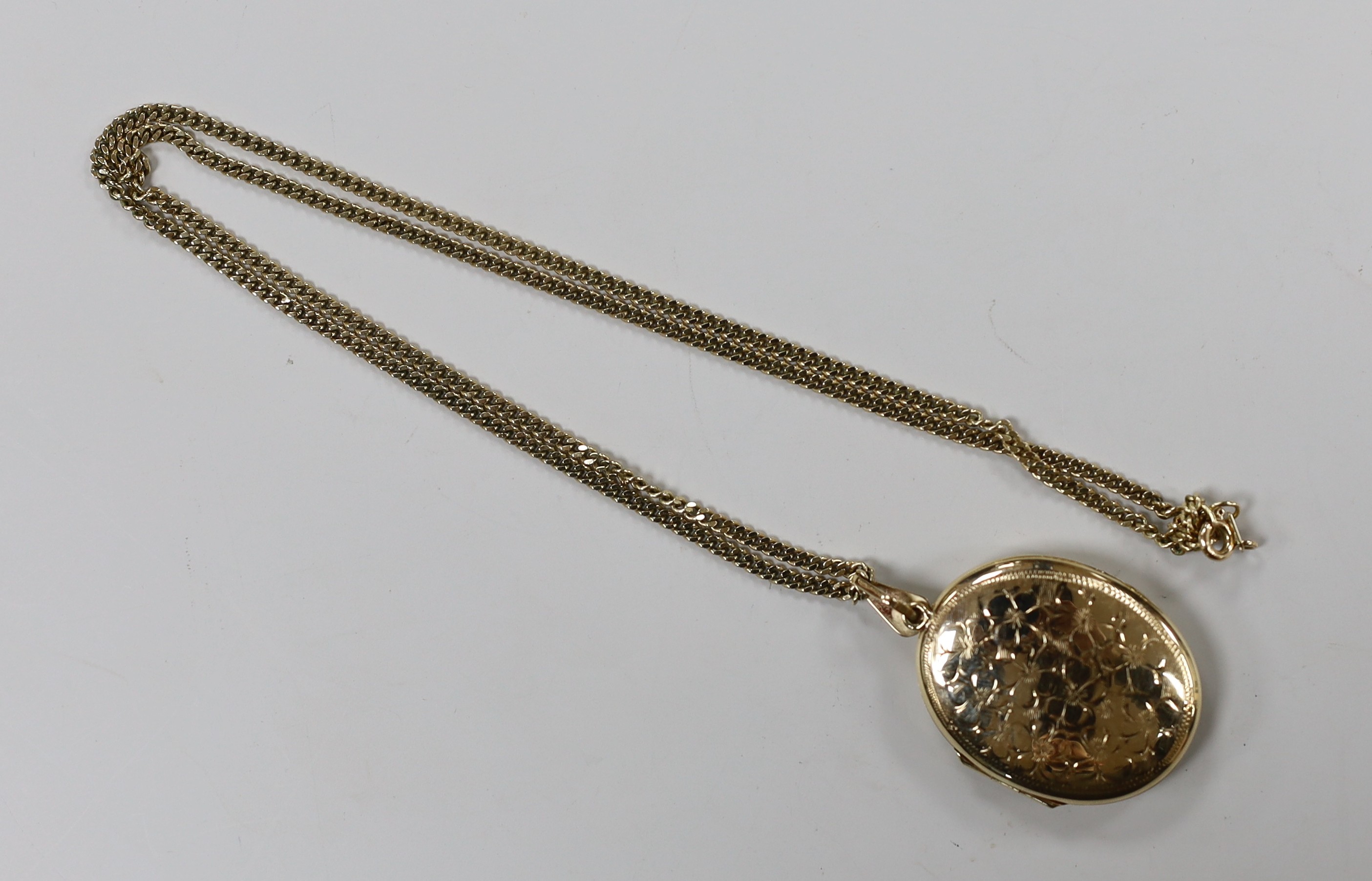 A modern 9ct gold oval locket, 33mm, on a 9ct gold chain, gross weight 16 grams.